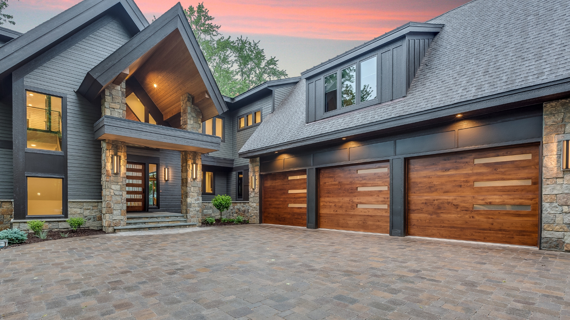 garage door installation A house with garage doors in natural wood color