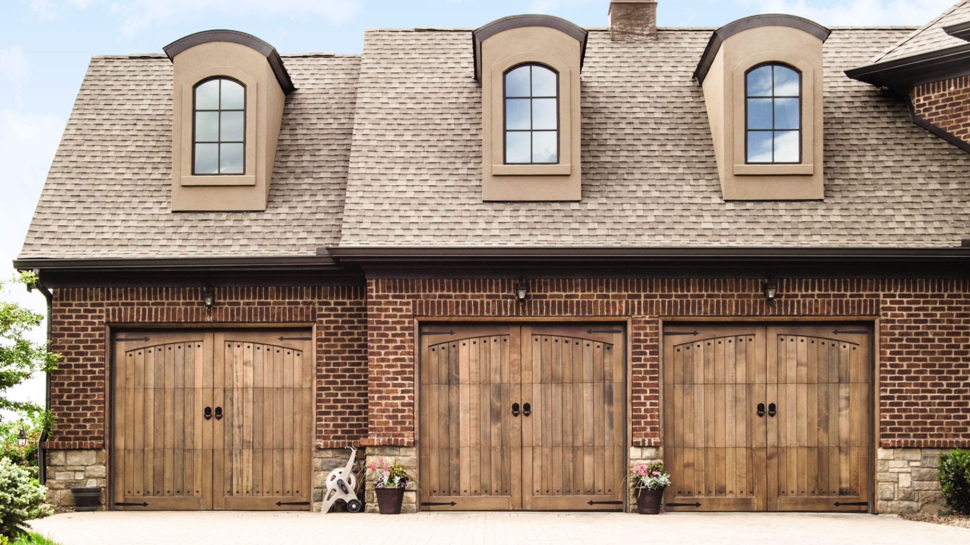 A garage with three doors with two-car garage door size