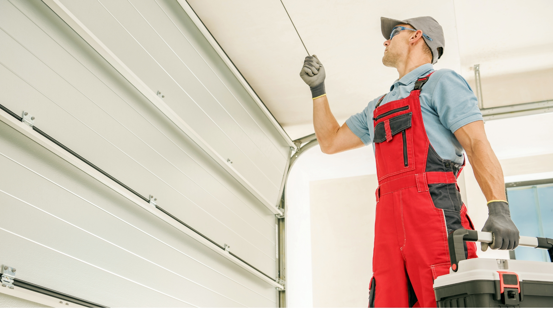 A technician installing sectional garage doors