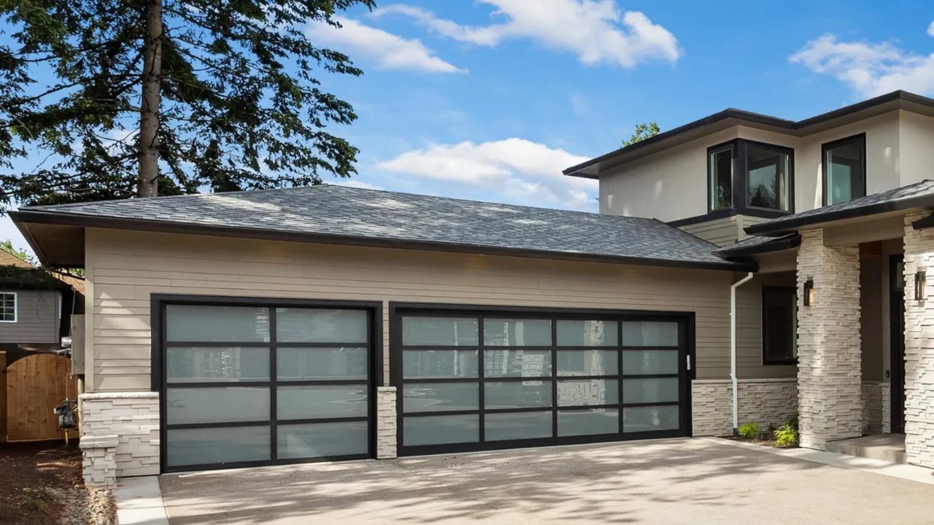 A house with aluminum glass garage doors. This is one of the types of garage doors