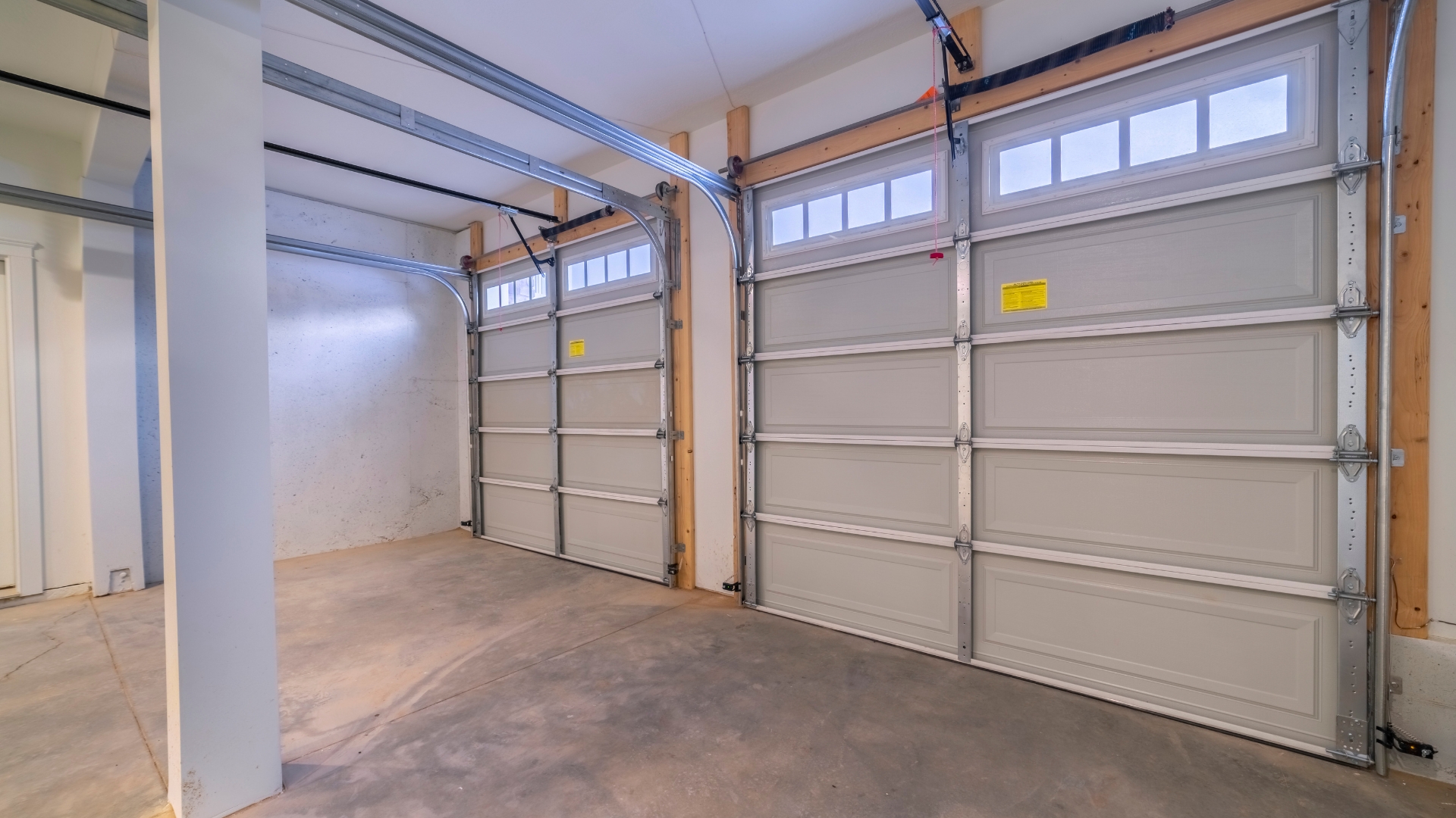 Garage doors with garage door storm braces