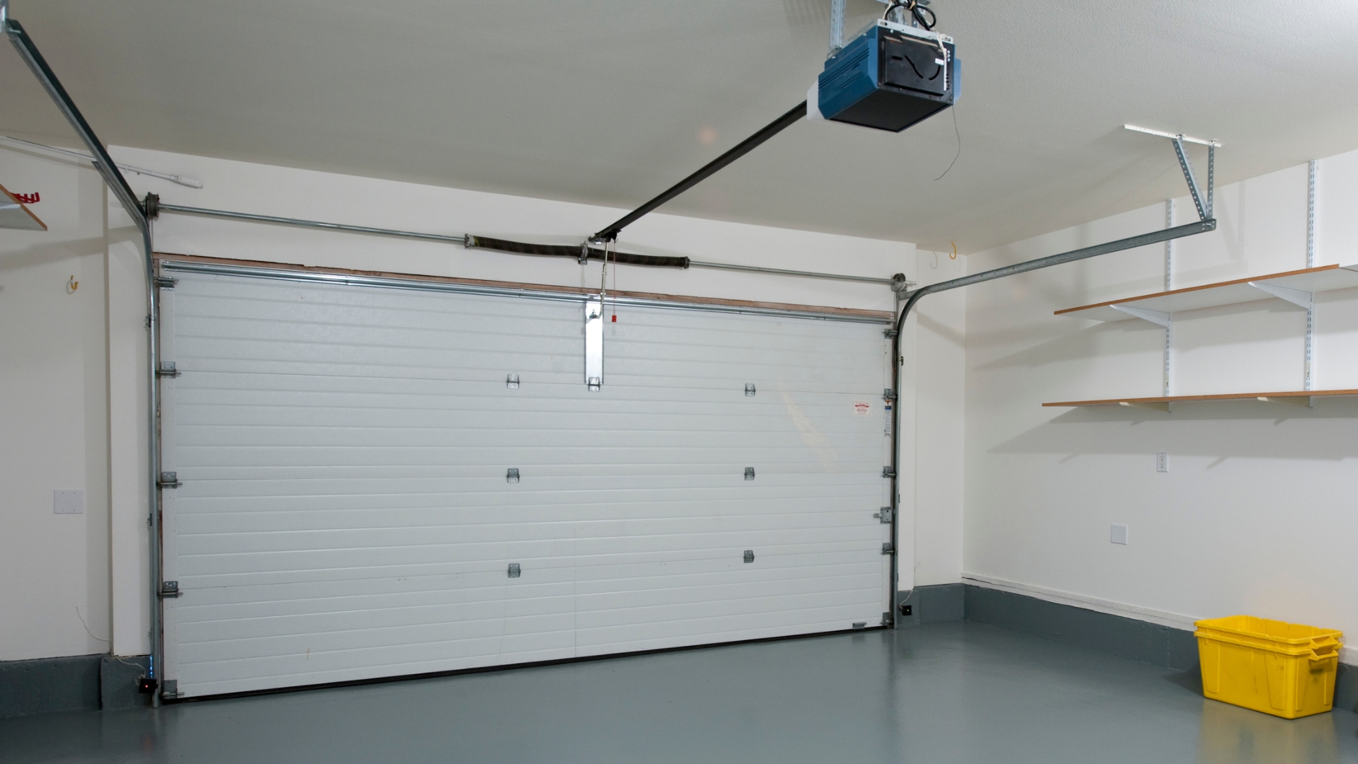 A residential garage door with tracks. opener, and other parts