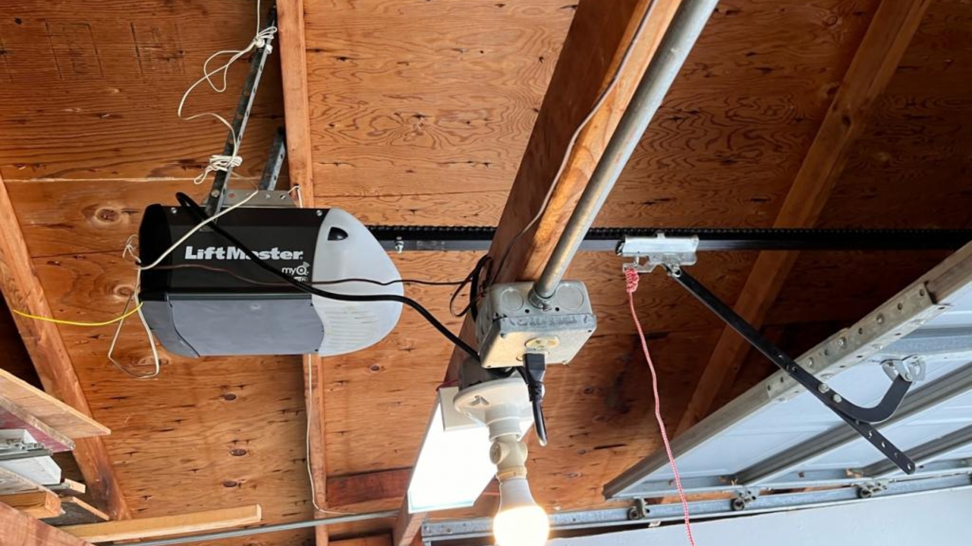 A LiftMaster garage door opener model installed on top of the garage ceiling