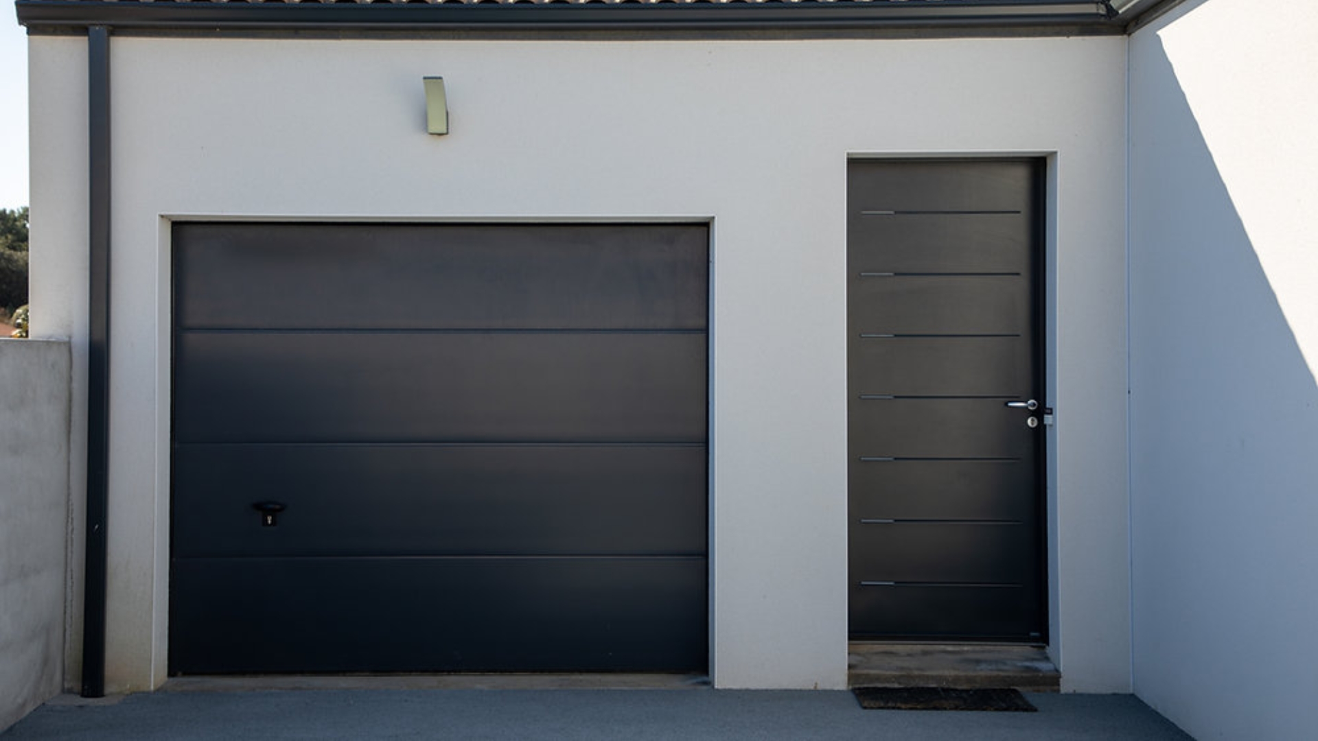 Narrow garage with a modern small garage door design