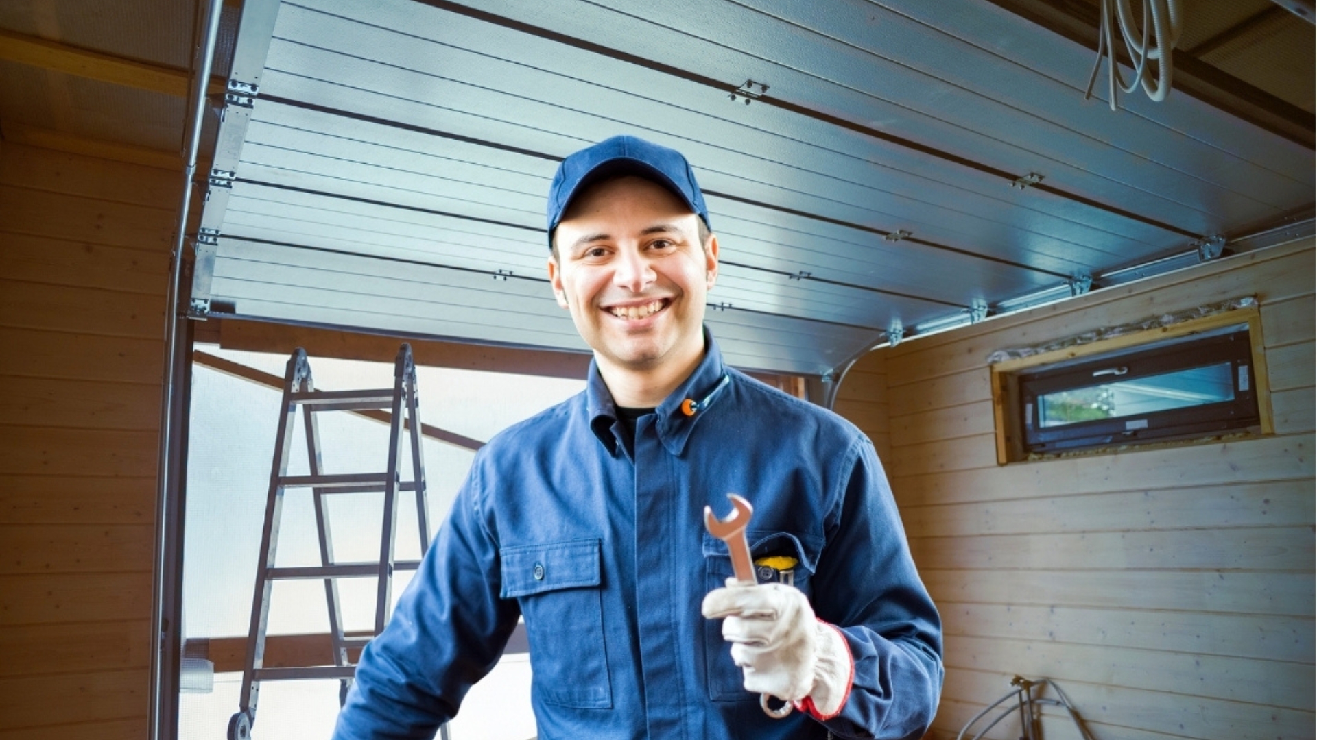 Garage door technician holding a wrench.