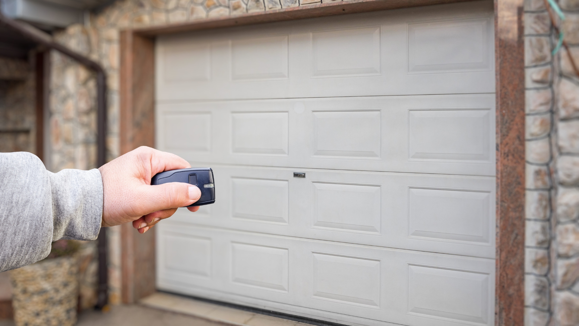 A homeowner trying to open a garage door with remote but it won’t move.